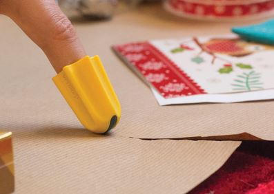 The one finger cutter is yellow and fits on the tip of your finger. Someone is using it to cut wrapping paper.