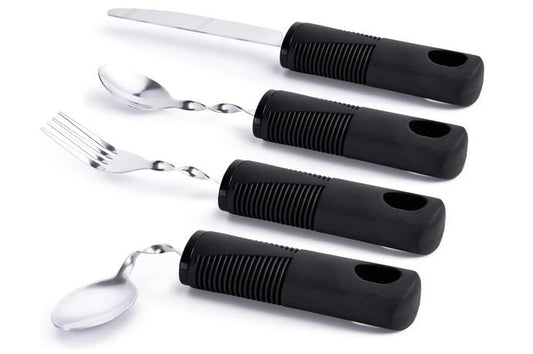 A set of utensils containing a knife, fork, teaspoon and tablespoon made from stainless steel. They have large black handles for easy gripping.