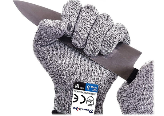 A gloved hand gripping the blade of the knife to show how cut resistant they are. They live life dangerously.