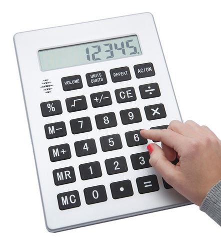 The jumbo calculator weighs in at a whopping 11.5" Tall and is 8.25" Wide. It's silver with black buttons that contain white numbers and signs. The button are 1" square pads with digits measuring 3/4" High. A person with red painted finger nails is about to press the #6