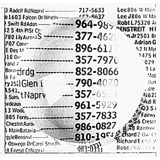 The clear 3" dome magnifier is highlighting numbers from an old book that used to have everyone listed with their name, address and phone number.