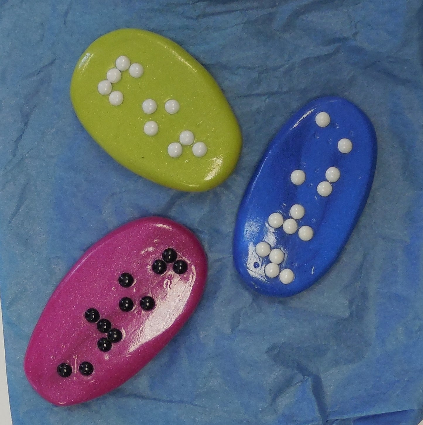3 flat braille stones in different colors