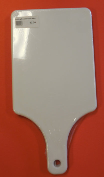 White cutting board paddle on orange table. Side A