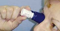 A person using the eye drop guide