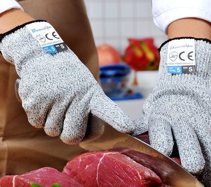 Someone cutting meat while wearing the gloves.