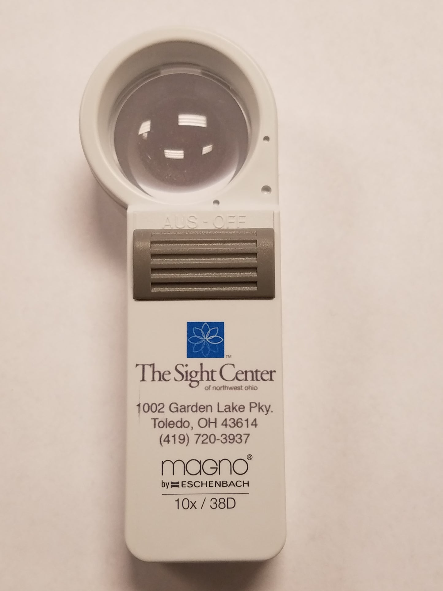 a 10x Hand Held Magnifier with the Sight Center Logo, address and phone number