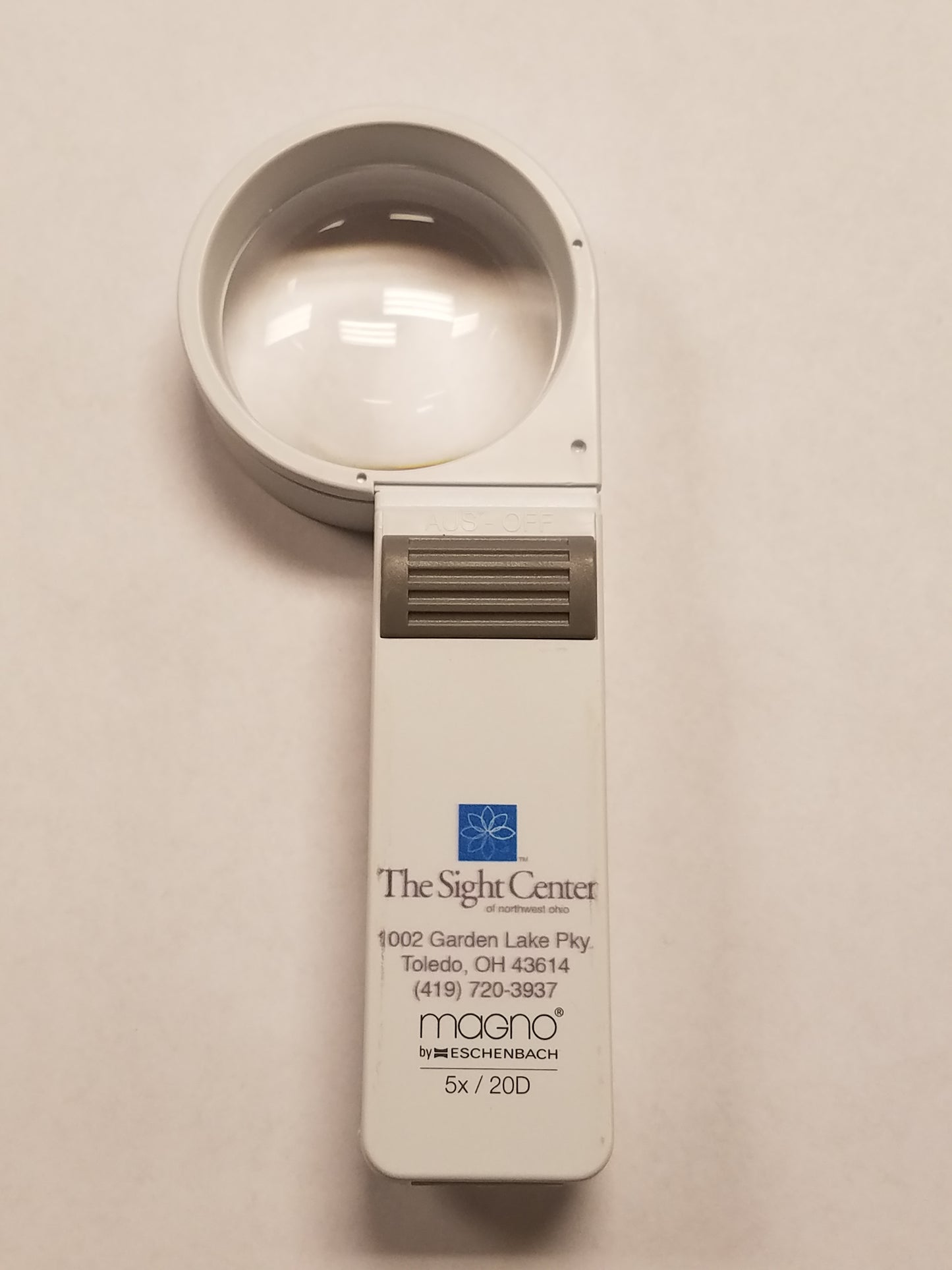 a 5x Hand Held Magnifier with the Sight Center Logo, address and phone number