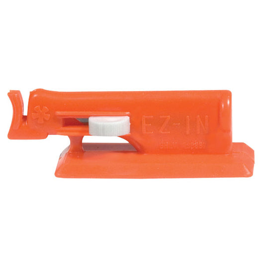 An orange device that has a white lever on the front that slides side to side and a little nose hook on the end where you insert the needle