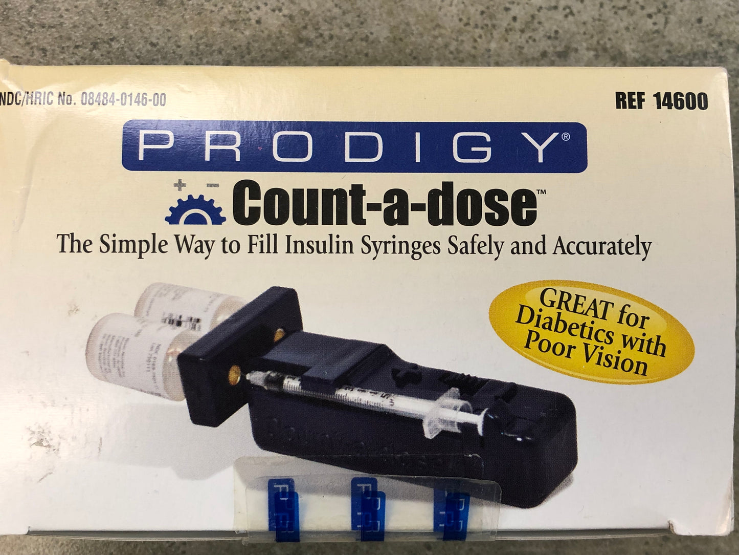The Prodigy Count-A-Dose packaging showing the syringe locked into the palstic unit to fill from the bottles