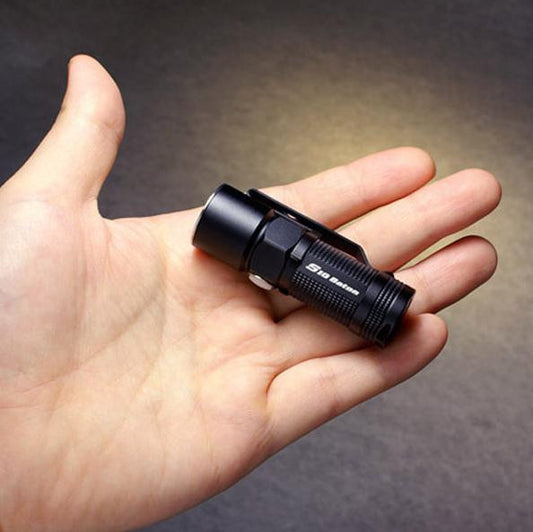 Tiny little black flashlight that fits in the palm of your hand