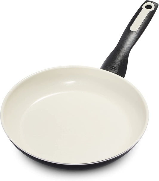 White frying pan with black handle