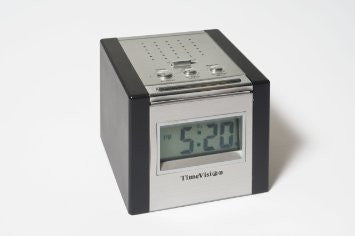 cube digital clock in silver and black showing it's 5 o clock somewhere